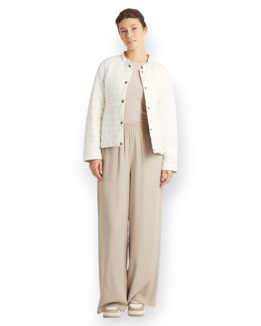 Model wearing Birdie by Nina Liddle Design white matte reversible down jacket with press button closure