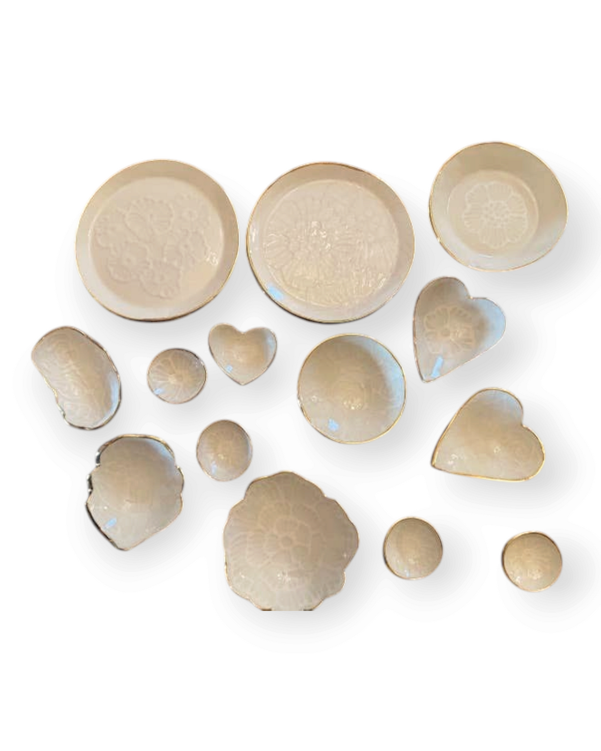 Birdie by Nina Liddle Design collection of handmade cream ceramic dishes with floral patterns and 22K gold rims.