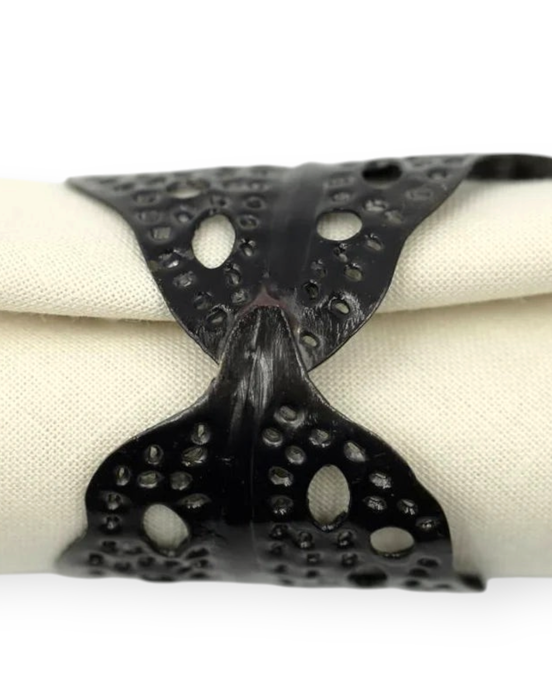 Birdie by Nina Liddle Design black sea kelp napkin ring with intricate leaf pattern holding a cream linen napkin