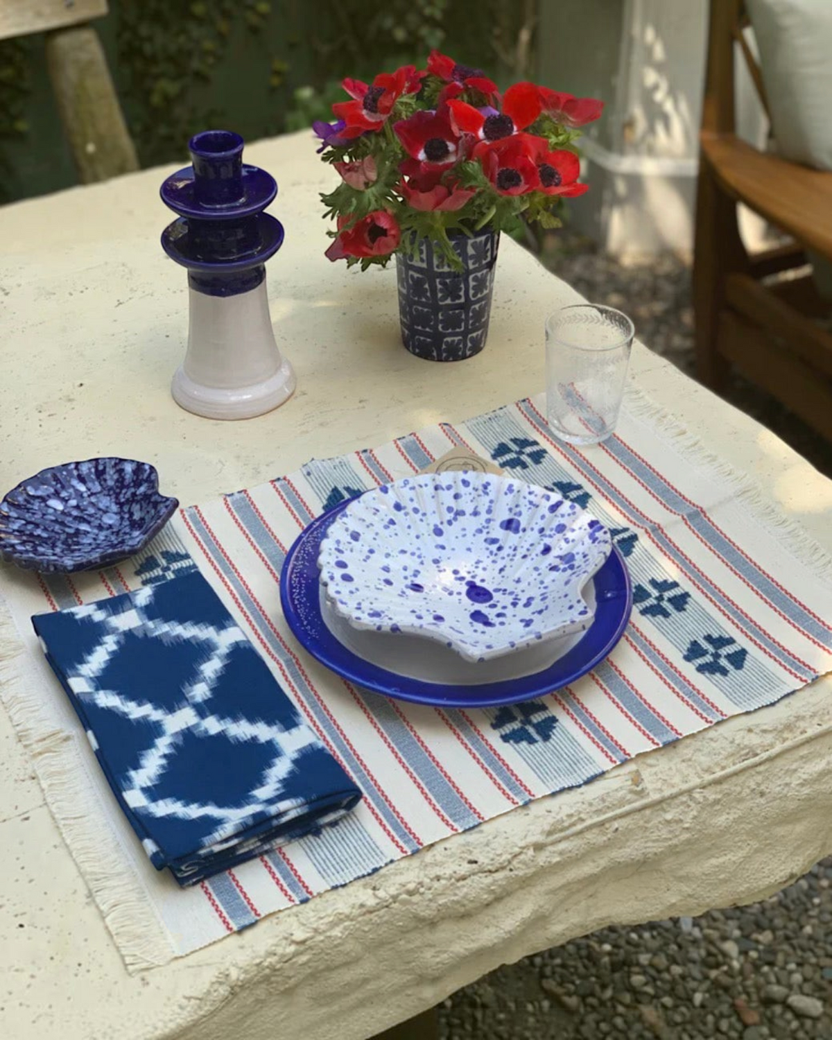 Birdie by Nina Liddle Design Concha ceramic dessert plate with blue and white splatter pattern on a table setting