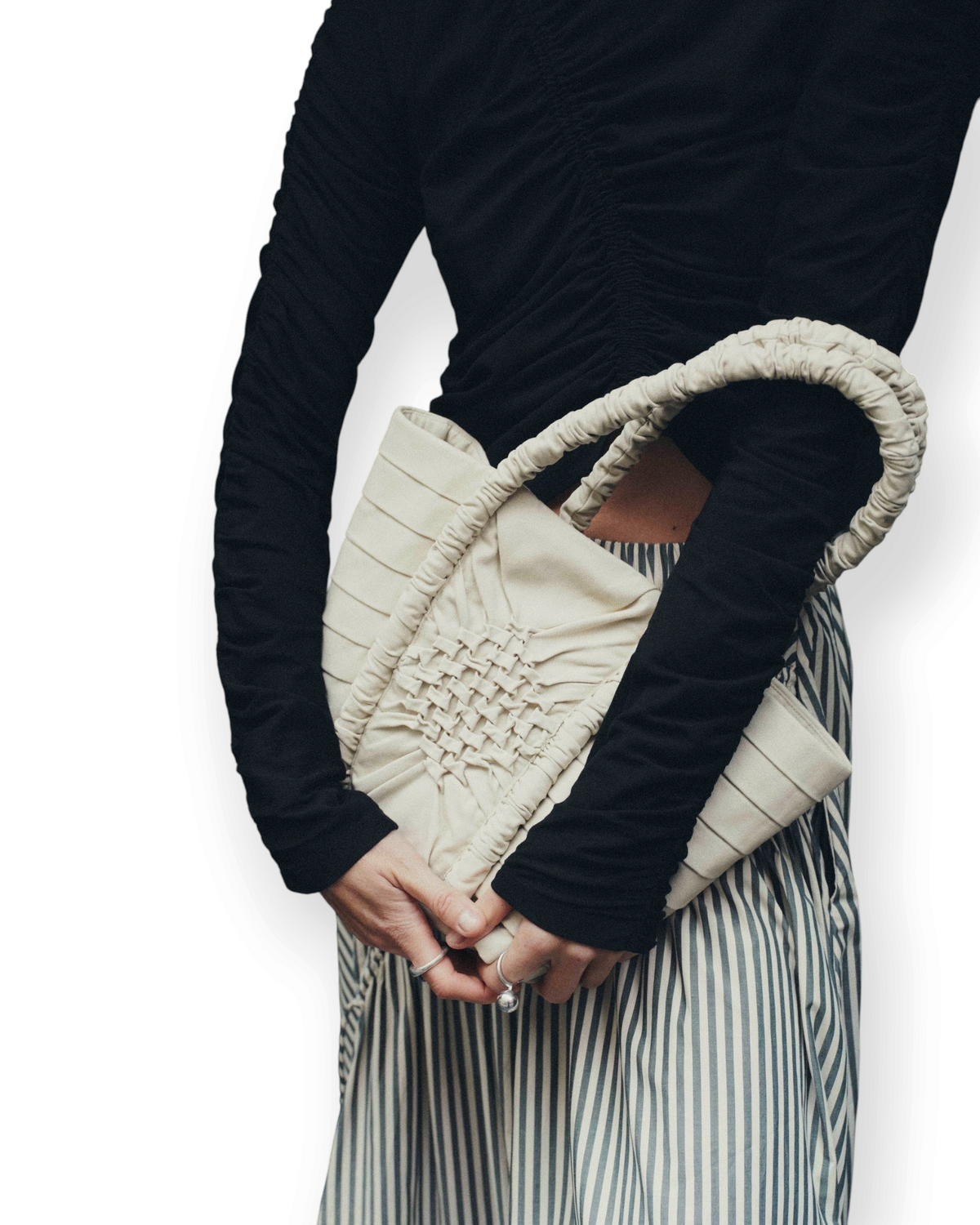 Birdie by Nina Liddle Design Miren bag in cream cotton twill with geometric smocking and ruched handle held by model