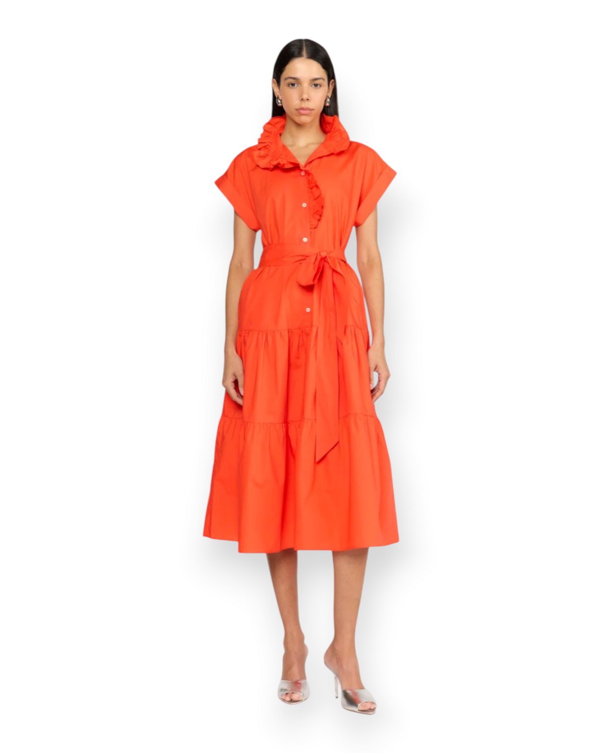 Model wearing a Birdie by Nina Liddle Design Jonah dress in bright orange cotton poplin with ruffles and a tie waist.