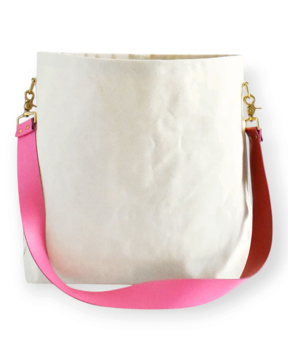 Birdie by Nina Liddle Design white canvas tote bag with a detachable pink leather crossbody strap and gold hardware.