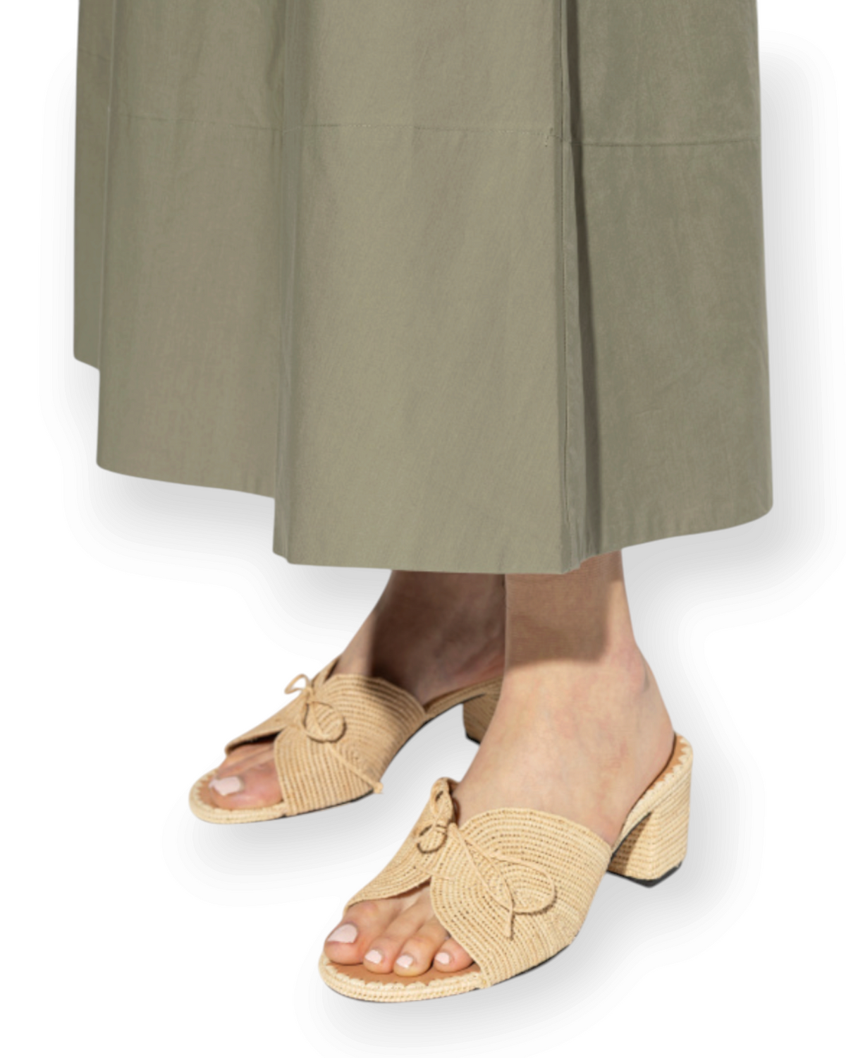Birdie by Nina Liddle Design Odett raffia mules with braided bow detail and block heel worn with olive midi skirt
