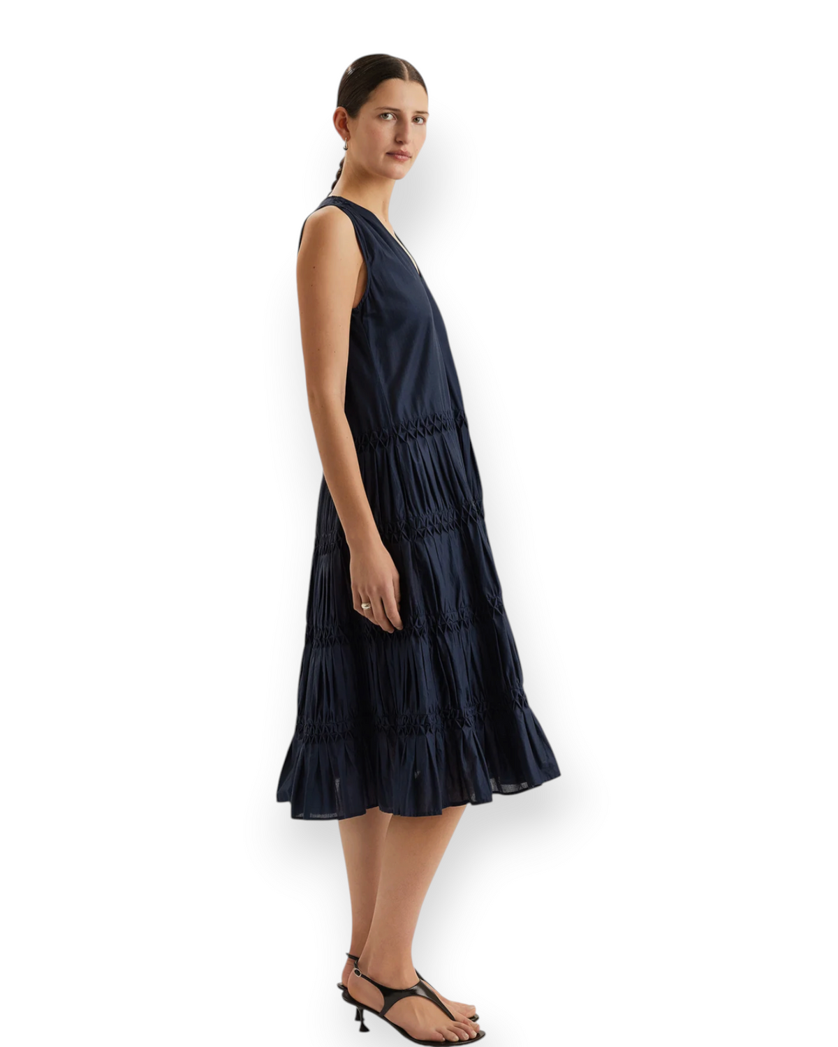 Birdie by Nina Liddle Design navy blue Pima cotton midi dress with honeycomb smocking and tiered skirt on a model