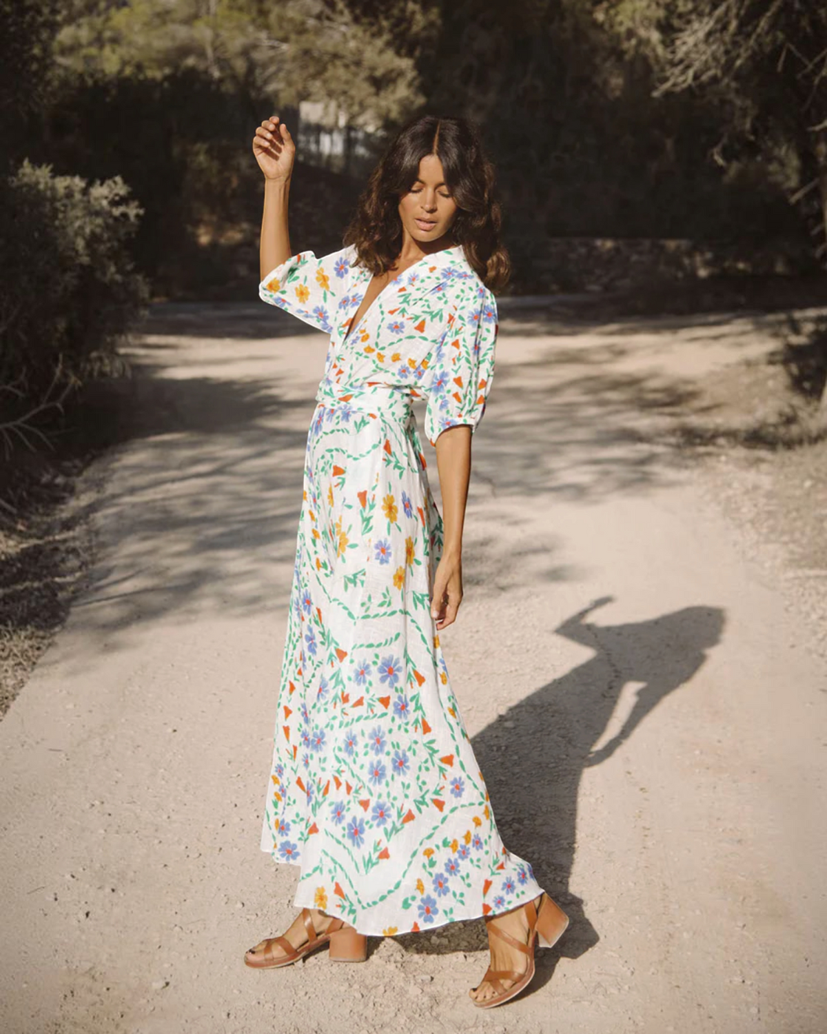 Birdie by Nina Liddle Design Bea ankle dress in white cotton linen with a colorful floral print and puffy sleeves.