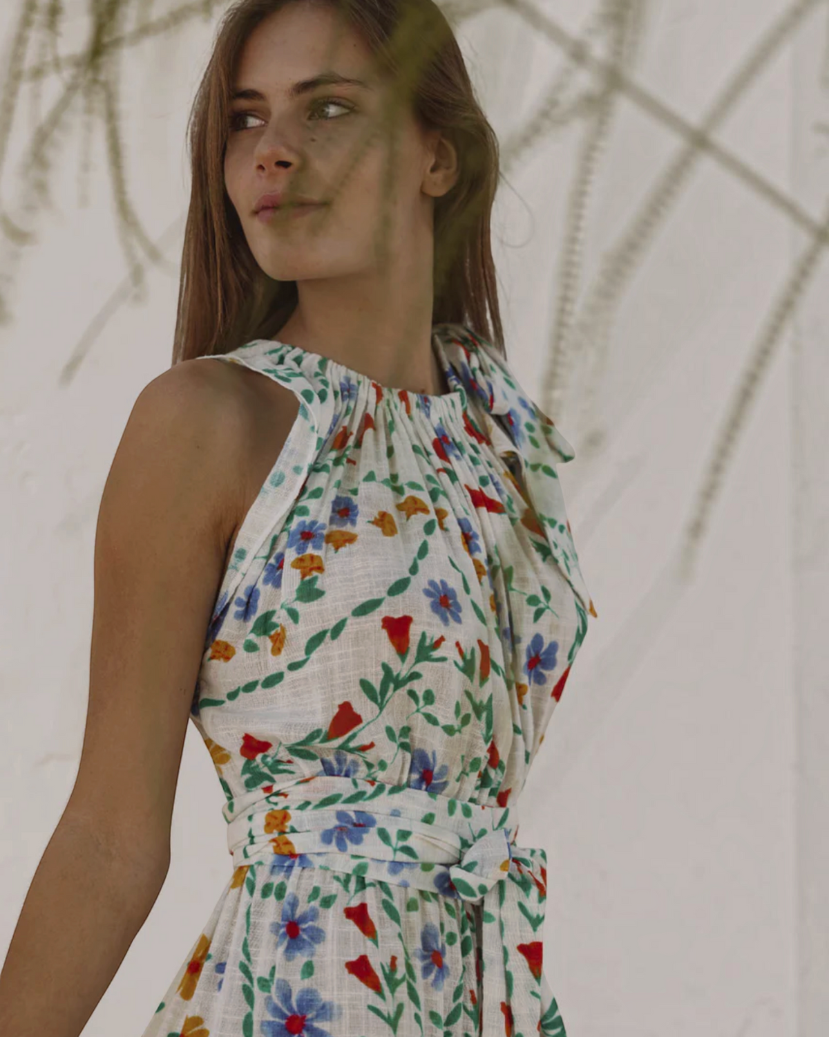 Birdie by Nina Liddle Design Malta floral cotton linen maxi dress with bow tie neck and sash belt on a model
