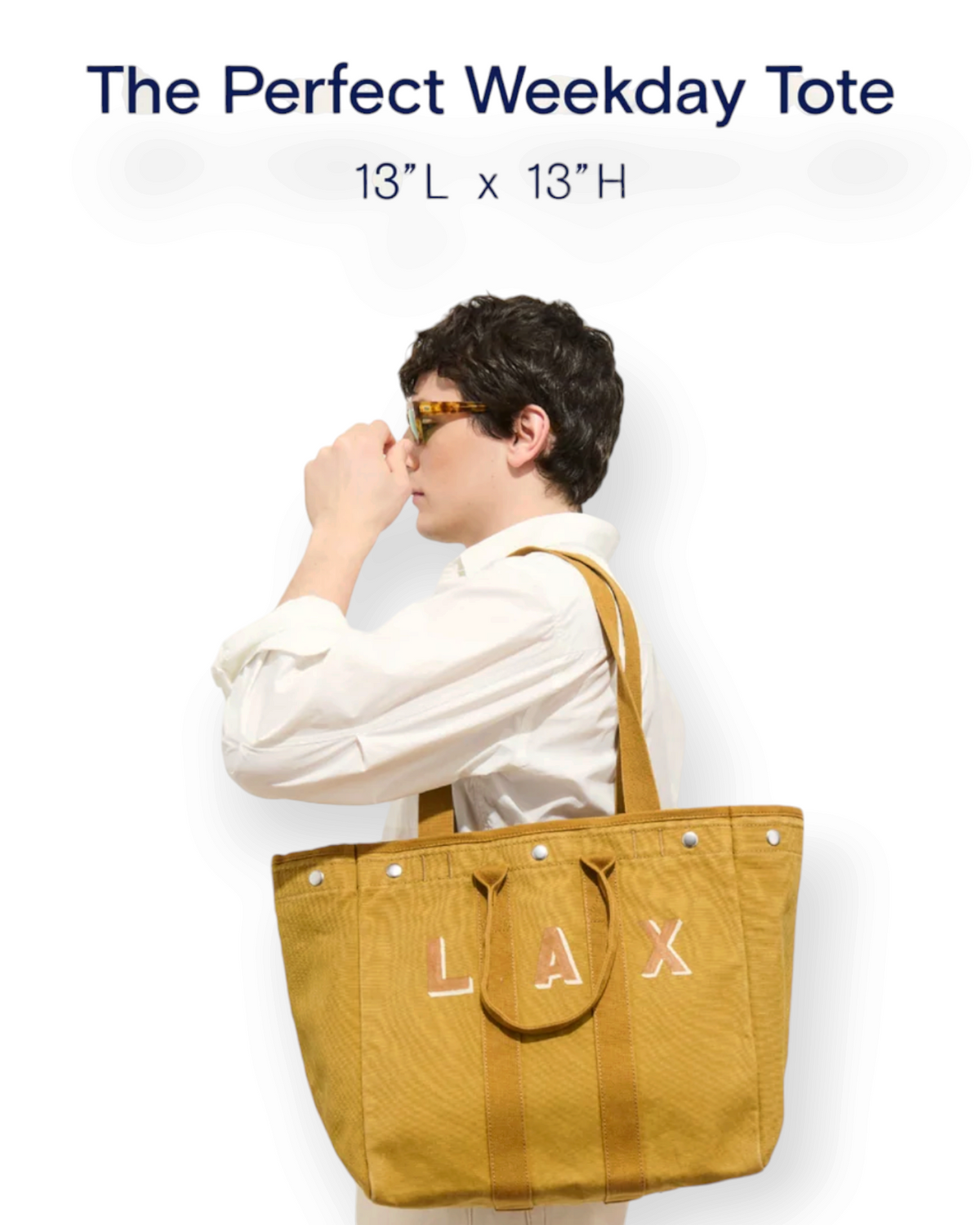 Birdie by Nina Liddle Design mustard yellow cotton tote bag with LAX lettering carried over the shoulder by a man.