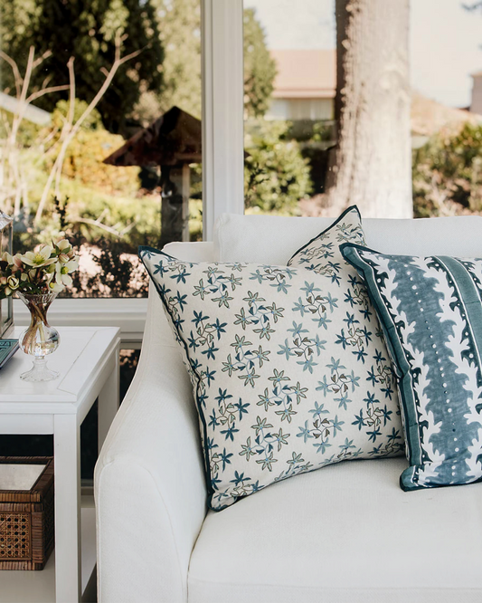 Birdie by Nina Liddle Design Celeste linen pillow with blue floral embroidery on a white sofa
