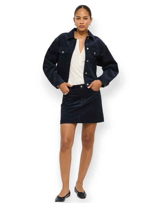 Birdie by Nina Liddle Design navy blue corduroy cropped jacket worn with a matching skirt and white henley top.