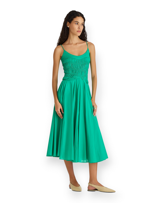 Model wearing a green Birdie by Nina Liddle Design Kaede dress with a ruched bodice and adjustable straps.