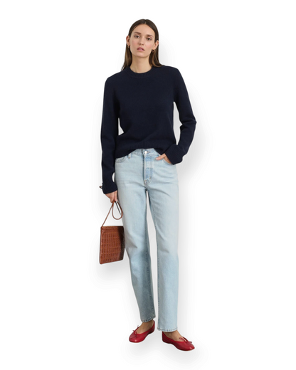 Birdie by Nina Liddle Design Marais navy blue washed cashmere sweater worn by a model with light wash jeans