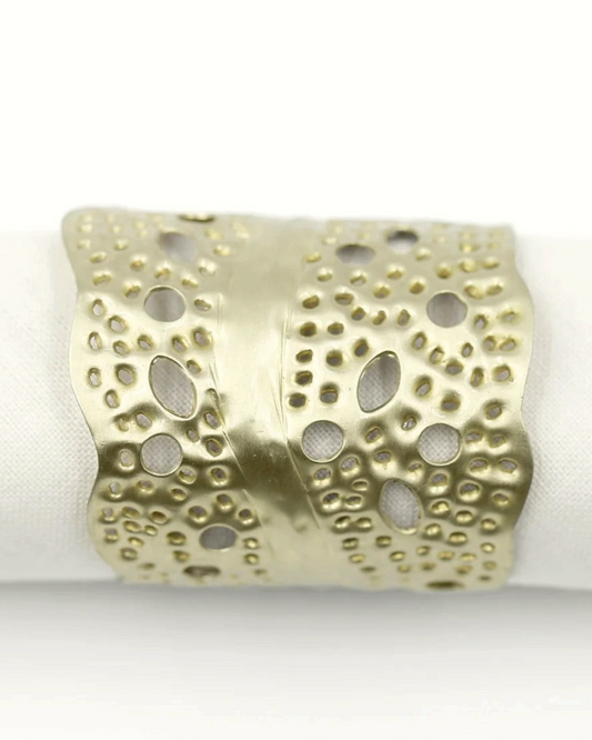 Birdie by Nina Liddle Design gold sea kelp napkin ring with intricate cut-out leaf pattern on a white napkin