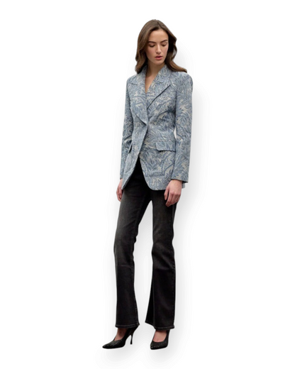Model wearing a Birdie by Nina Liddle Design blue floral jacquard single breast blazer with structured shoulders.