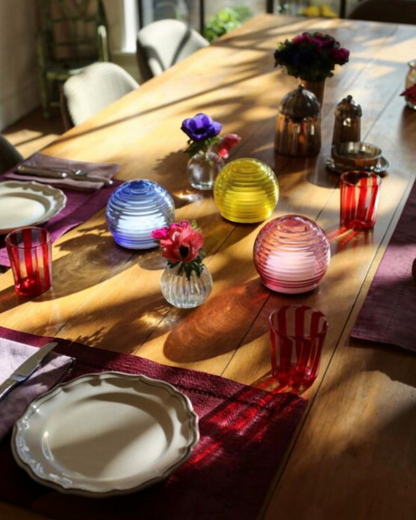 Birdie by Nina Liddle Design portable handblown Murano glass table lights in blue, yellow, and pink on a dining table