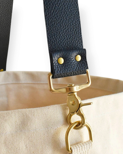 Birdie by Nina Liddle Design canvas tote bag featuring a detachable navy blue textured leather strap with brass clips