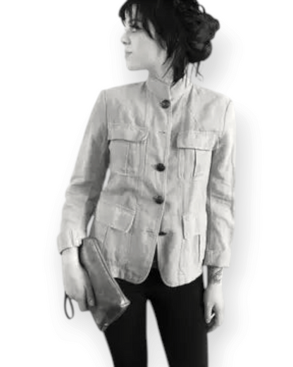 Birdie by Nina Liddle Design Pinched bottom Traveller Small leather handbag held by a woman in a utility jacket