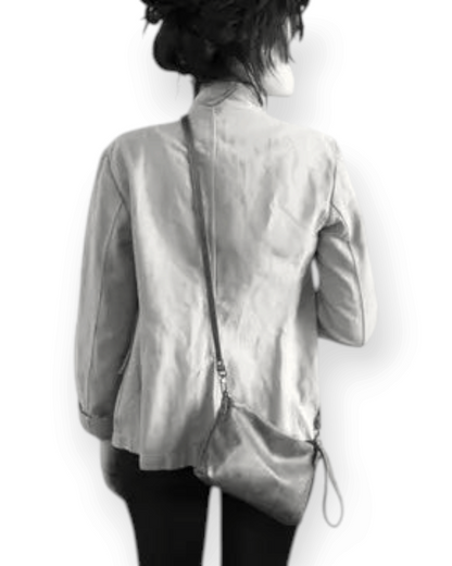 Birdie by Nina Liddle Design Pinched bottom Traveller Small leather crossbody bag worn by a woman from behind