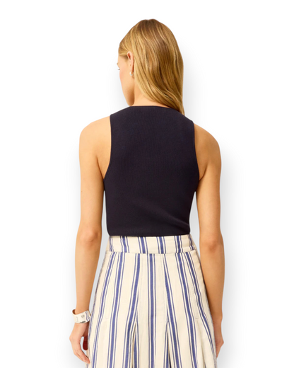 Birdie by Nina Liddle Design Miranda tank in navy ribbed knit fabric, back view on a model with striped skirt.