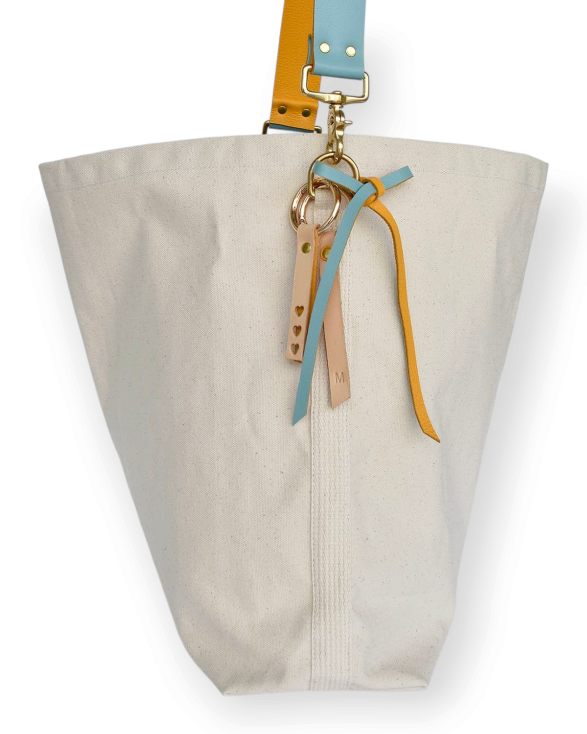 Birdie by Nina Liddle Design canvas tote bag with detachable blue and yellow leather straps and decorative charms.