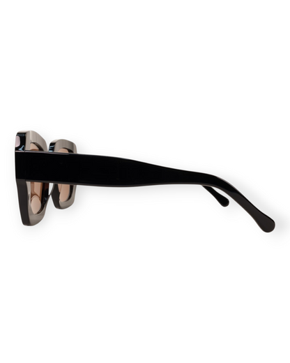 Birdie by Nina Liddle Design Ann oversized black sunglasses with a wide fit, shown from a side profile view.
