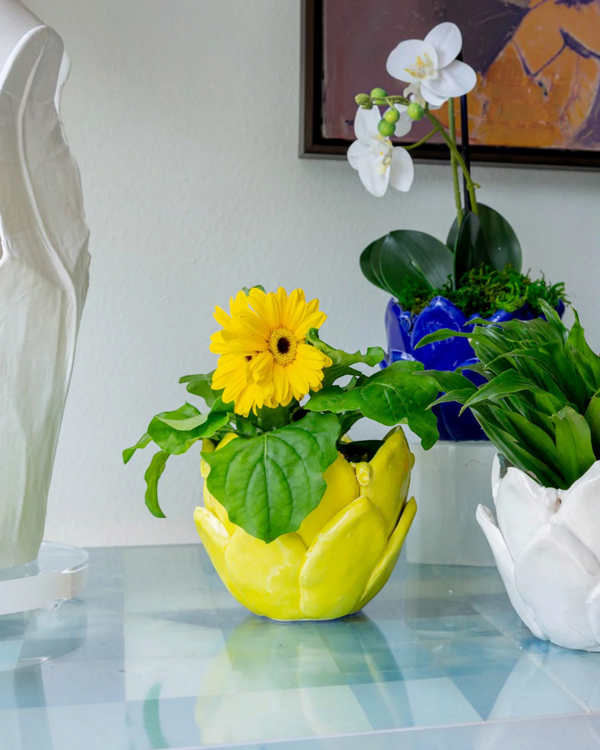 Birdie by Nina Liddle Design handmade yellow Italian ceramic artichoke catchall pot holding a bright yellow flower.