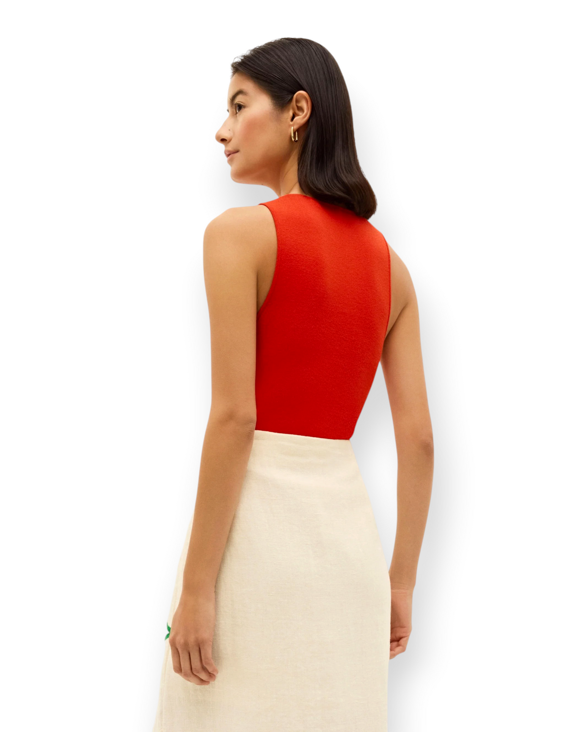 Model wearing a Birdie by Nina Liddle Design red ribbed knit Miranda tank top tucked into a cream skirt