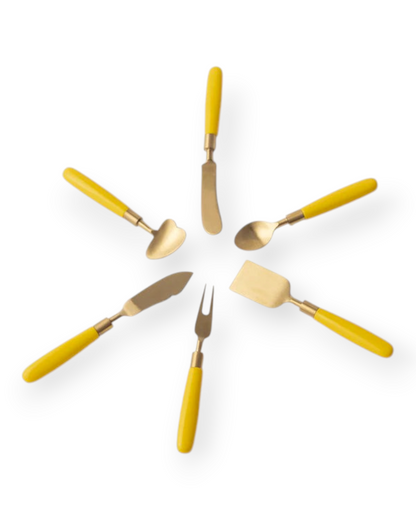 Birdie by Nina Liddle Design six-piece cheese knife set with vibrant yellow resin handles and shiny gold-tone brass