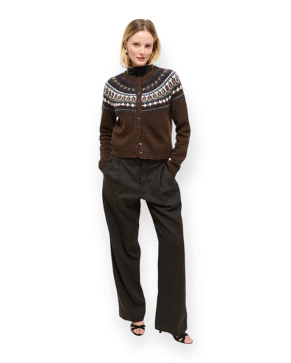 Birdie by Nina Liddle Design brown wool Fairisle cardigan with shell buttons worn by a model in dark trousers