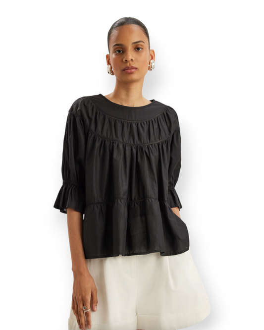 Birdie by Nina Liddle Design Sol blouse in black Pima cotton with boat neck, crochet lace trim, and puff sleeves.