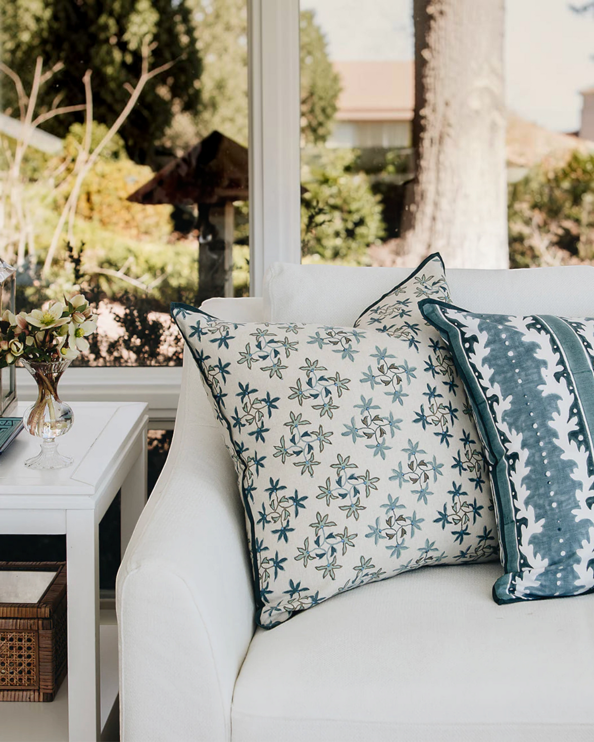 Birdie by Nina Liddle Design Celeste linen pillow with blue floral embroidery on a white sofa