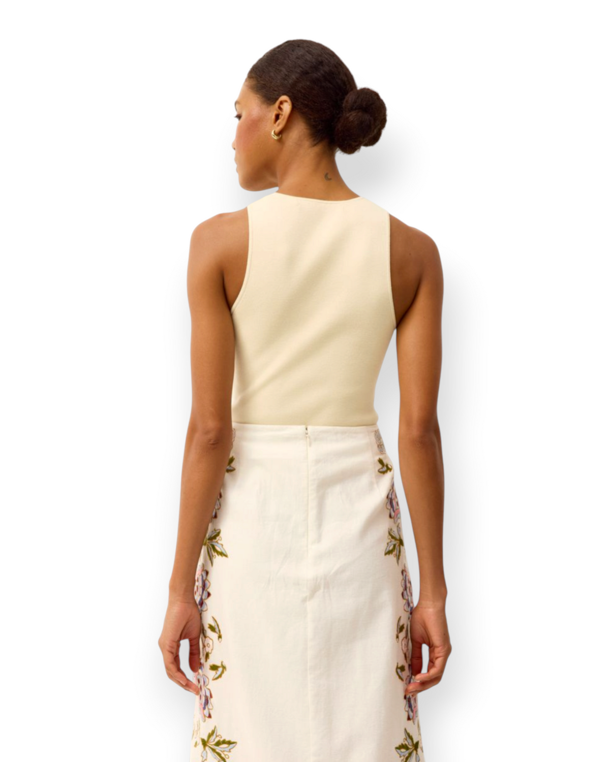 Model wearing a Birdie by Nina Liddle Design Miranda tank in cream ribbed knit fabric, back view.