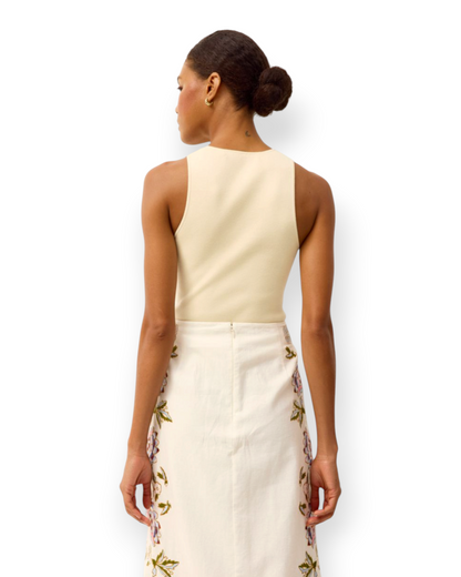Model wearing a Birdie by Nina Liddle Design Miranda tank in cream ribbed knit fabric, back view.