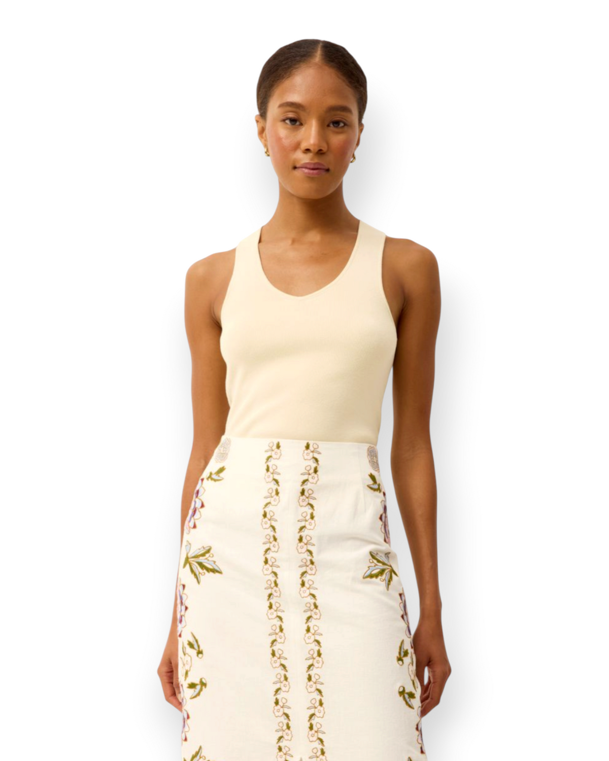 Model wearing a Birdie by Nina Liddle Design Miranda tank in cream ribbed knit fabric with a scoop neckline