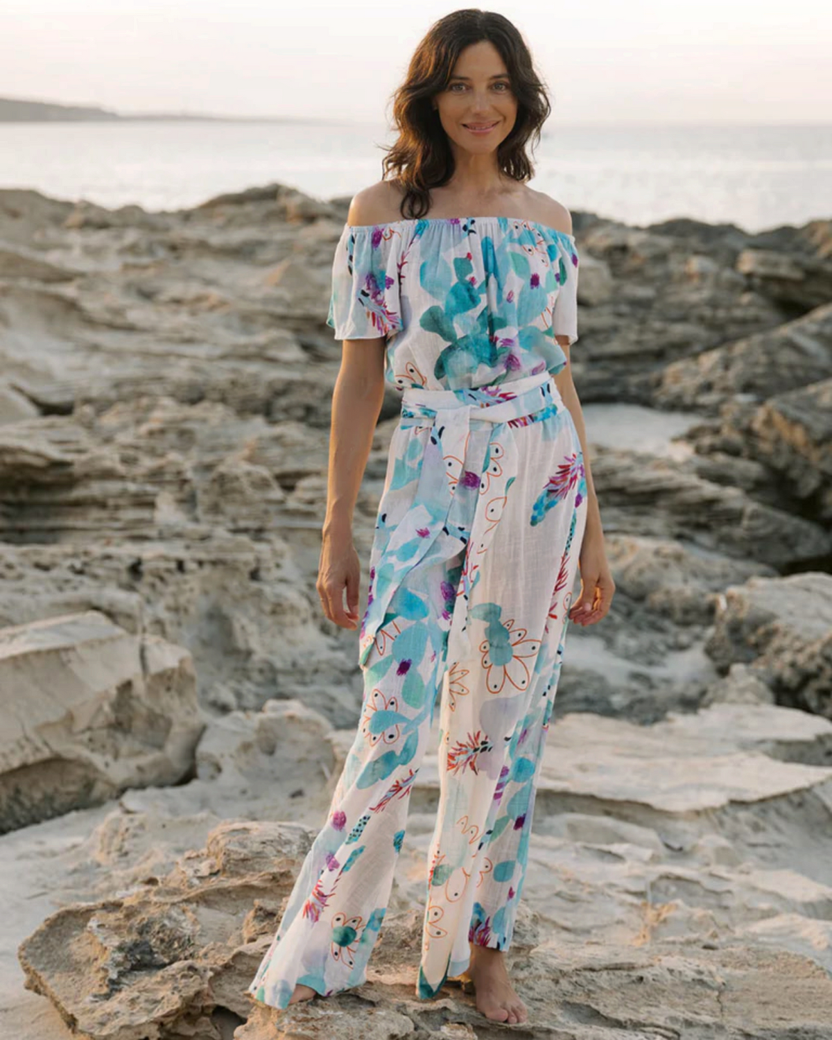 Birdie by Nina Liddle Design Dani jumpsuit in white cotton linen with blue and orange floral print and sash belt