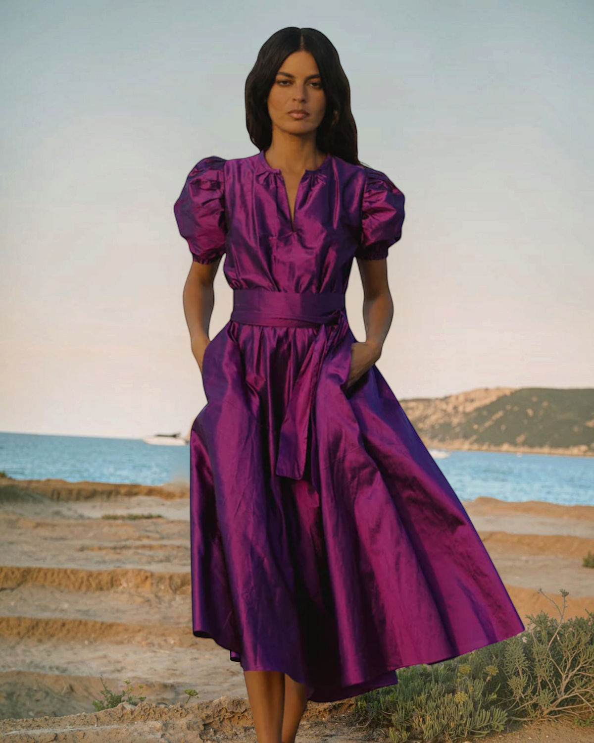Birdie by Nina Liddle Design Brooke midi dress in purple silk taffeta with pleated cap sleeves and matching sash belt.
